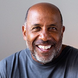 Closeup of senior man in gray shirt smiling