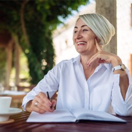 woman smiling while journaling 