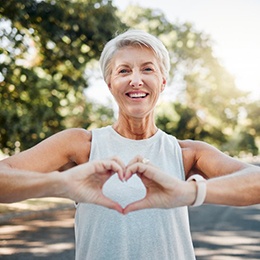 Lady makes shape of heart with her hands