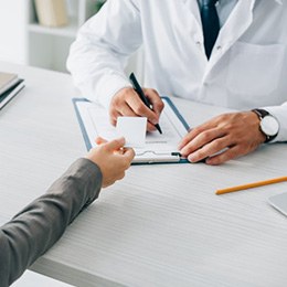Dentist and patient discussing cost of care