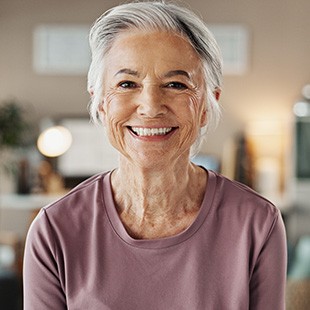 Older woman pleased with her smile after seeing Canadian Dental Care Plan dentist in Nepean