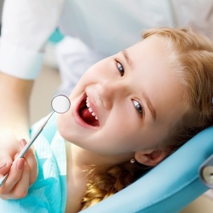 Young girl smiling during dental checkup