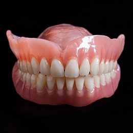 Close-up of dentures on black surface