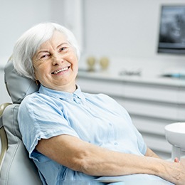Senior woman sitting in dental chair smiling