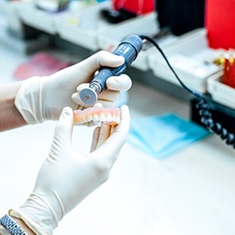 Technician working on dentures in dental lab
