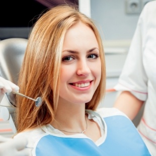 Young blonde woman smiling in dental chair