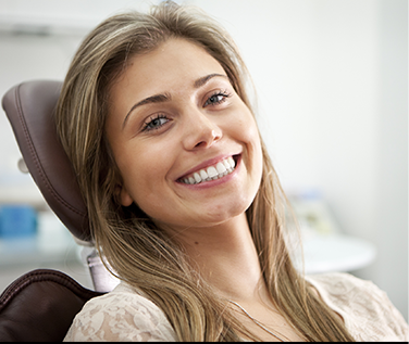 Young blonde woman grinning in dental chair
