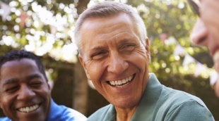 Group of older men laughing together outdoors