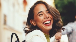 Laughing woman sitting on a bench