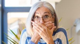 Surprised woman covering her mouth with her hands