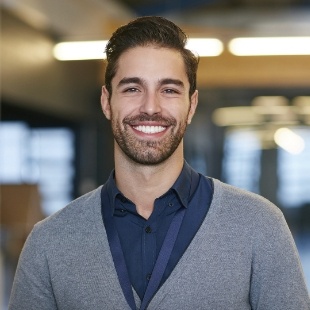 Man in grey cardigan smiling after preventive dentistry in Nepean