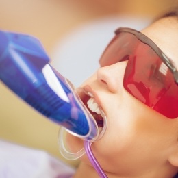 Young girl getting fluoride treatment during preventive dentistry visit