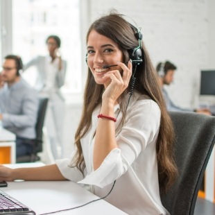 Smiling dental team member talking on phone