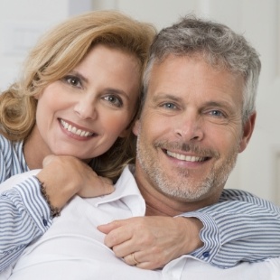 Older man and woman smiling thanks to restorative dentistry in Nepean