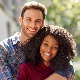 Man and woman hugging in their front yard