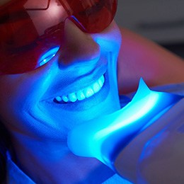 Patient smiling during in-office teeth whitening treatment