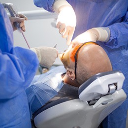 Dentists performing a wisdom tooth extraction surgery
