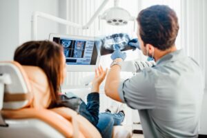 a dentist showing a patient her X-rays