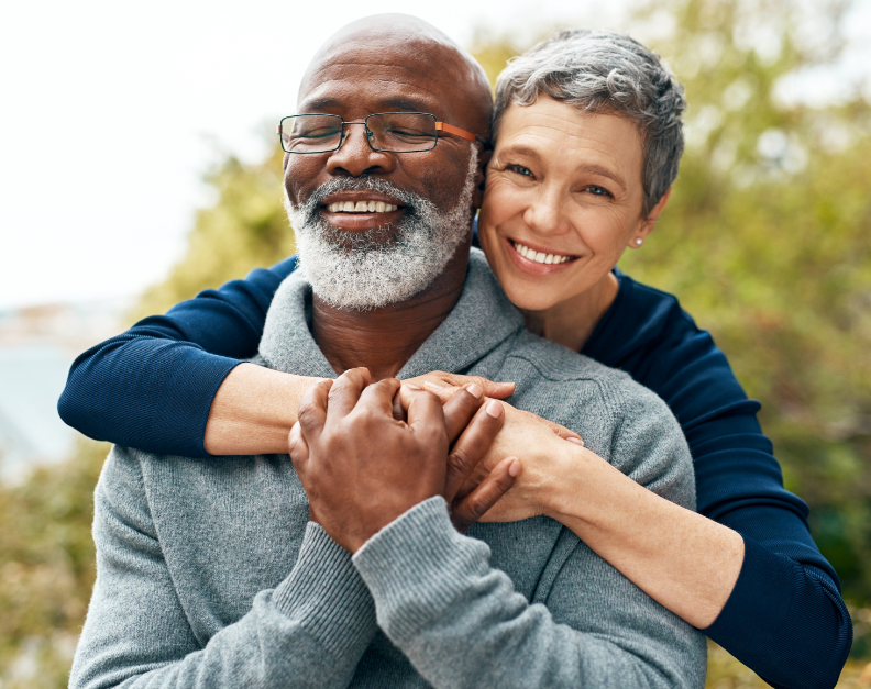 Older couple smiling with bright white teeth