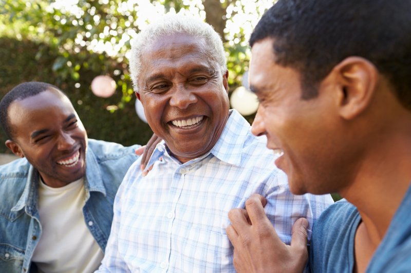 Patient with dentures talking with family